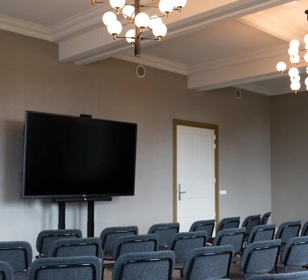 Theateropstelling met stoelen gericht op het scherm voor presentatie in de Mauritskazerne